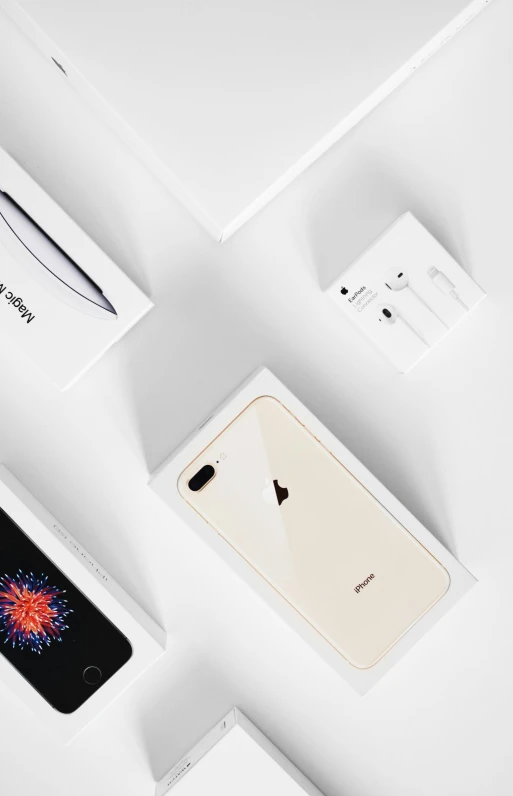 a group of electronics sitting on top of a white surface, iphone detailed photo, packaging, 2 5 6 x 2 5 6, golden apple