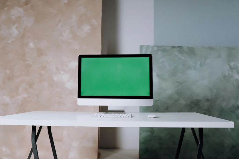 a computer monitor sitting on top of a white desk, inspired by Elsa Bleda, trending on pexels, computer art, green clothes, screens, skin painted with green, plain background