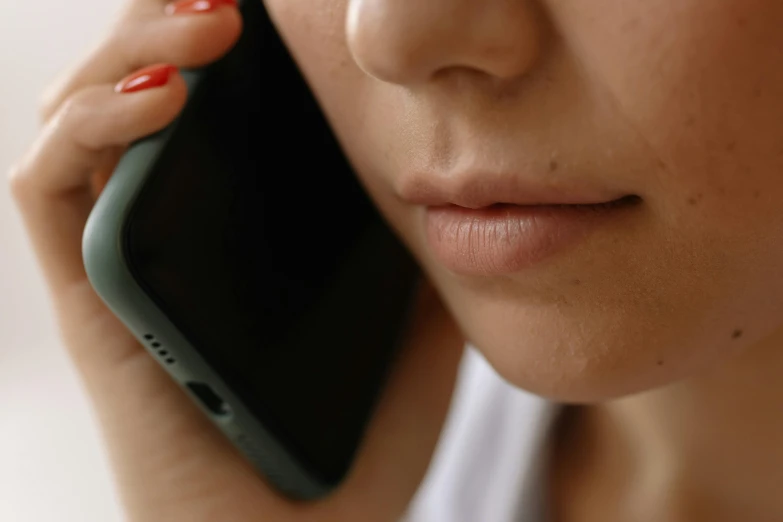 a close up of a person talking on a cell phone, faint red lips, less detailing, she's sad, phone