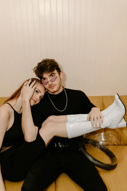 a man and a woman sitting on a couch, an album cover, trending on pexels, joey king, boots, high quality photo, head shot