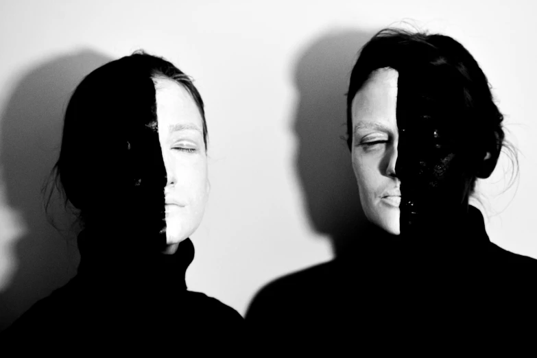 a couple of women standing next to each other, a black and white photo, by Jan Rustem, purism, the mask covers her entire face, aphex twin, in a style blending æon flux, cmyk portrait