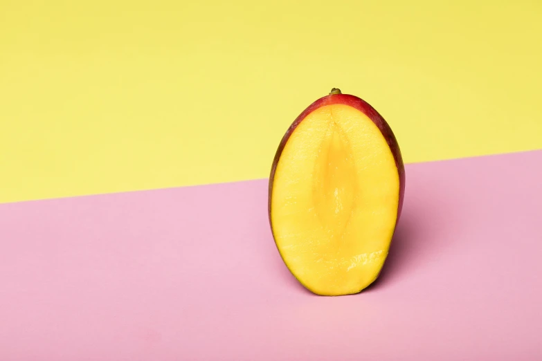 an apple cut in half on a pink and yellow background, inspired by Giorgione, trending on pexels, mango, light from right, on grey background, manuka