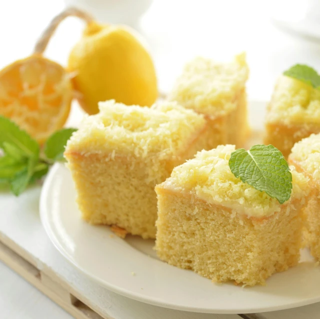 a white plate topped with four pieces of cake, a pastel, by Bernardino Mei, unsplash, hurufiyya, with lemon skin texture, square, premium quality, 15081959 21121991 01012000 4k