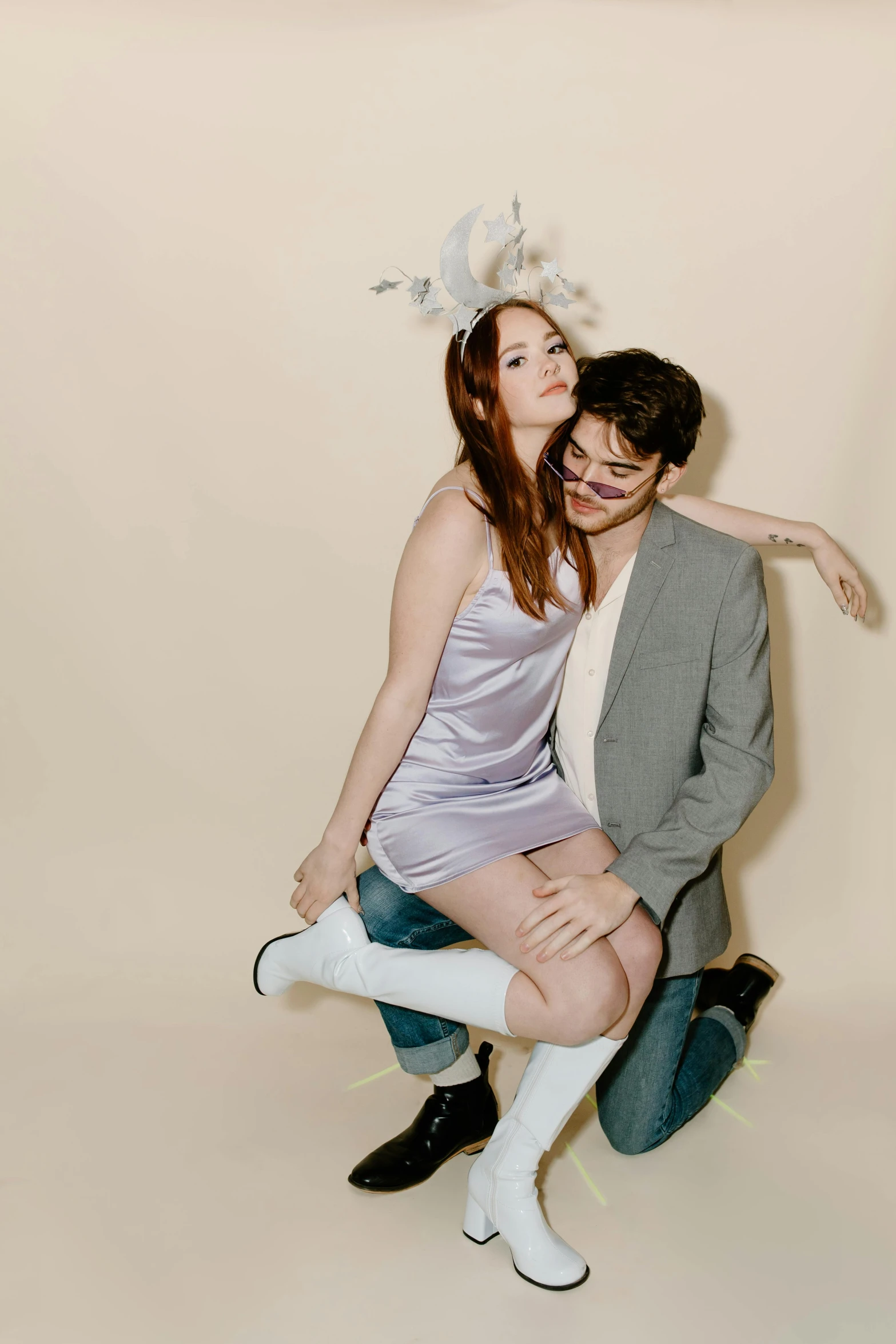 a man and a woman sitting next to each other, a portrait, by Anita Malfatti, unsplash, wearing a party hat, bunny leg, karen gillan, on a pale background