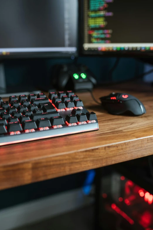 a computer keyboard sitting on top of a wooden desk, gaming room, black steel with red trim, multicoloured, rtx