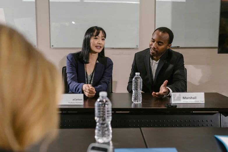 a man and a woman sitting at a table, happening, mix of ethnicities and genders, ayami kojima and lyde caldwell, professional image, background image