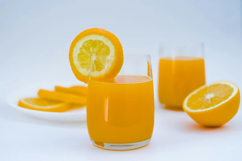 a glass of orange juice next to sliced oranges, by Nicolette Macnamara, pexels, on grey background, 🦩🪐🐞👩🏻🦳, anime shot, zoomed in shots