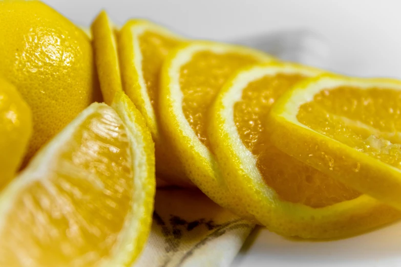 a close up of sliced oranges on a plate, a digital rendering, by Carey Morris, pexels, mono-yellow, thumbnail, lemonade, refreshing colour