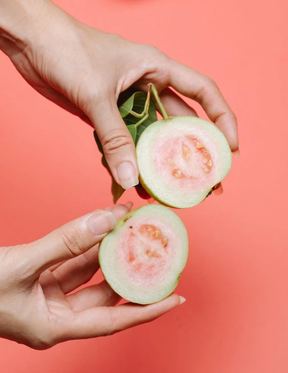 a close up of a person holding a piece of fruit, pink body, background image, greenish skin, multiple stories