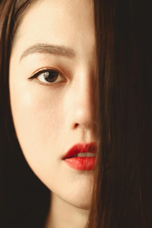 a close up of a woman with long hair, by Torii Kiyomoto, trending on pexels, hyperrealism, popular korean makeup, half face, of a youthful japanese beauty, only with red