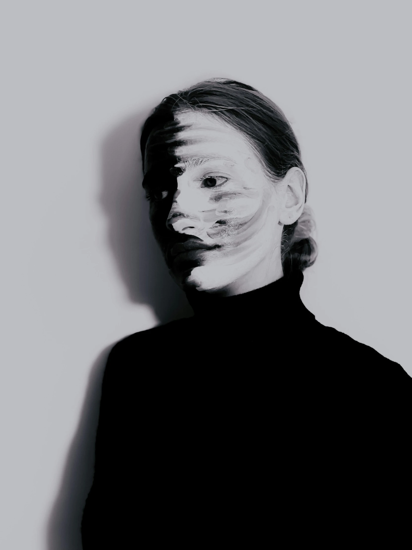 a black and white photo of a person with a mask on, inspired by Anna Füssli, wearing turtleneck, war paint, julia hetta, distorted