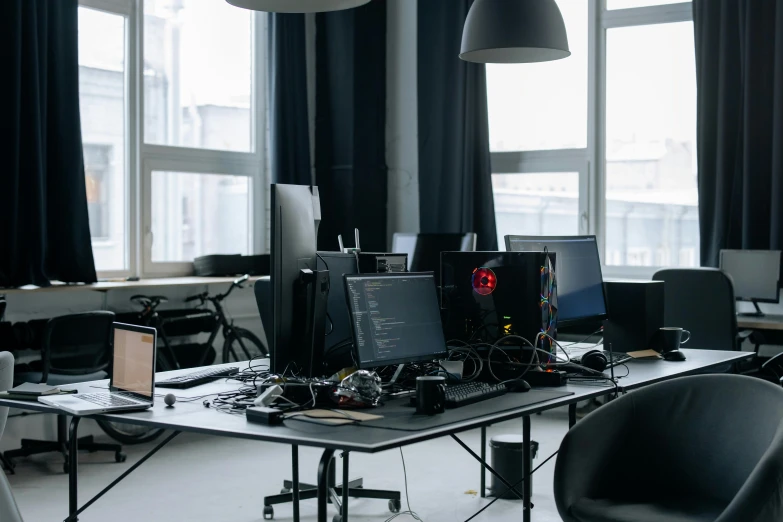 a group of computers sitting on top of a desk, unsplash, cybernetic culture research unit, black wired cables, ignant, developers