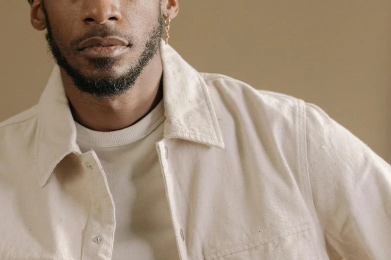 a close up of a person wearing a white shirt, an album cover, inspired by Barthélemy Menn, trending on pexels, wear's beige shirt, tonal topstitching, artist wearing overalls, muted colors. ue 5