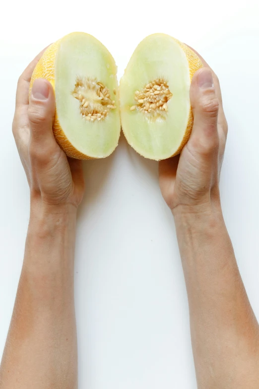 a person holding a half of a melon, a picture, by Matthias Stom, unsplash, renaissance, single pair of hands, no - text no - logo, hegre, half male and half female