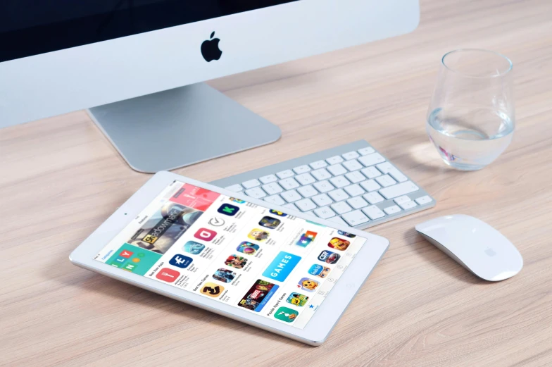 a tablet computer sitting on top of a wooden desk, trending on pexels, square, ios app icon, 9 9 designs, sleek white