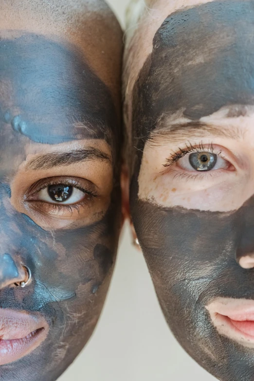 two people with facial masks on their faces, trending on pexels, pointed face and grey eyes, brown mud, blue-black, body and face
