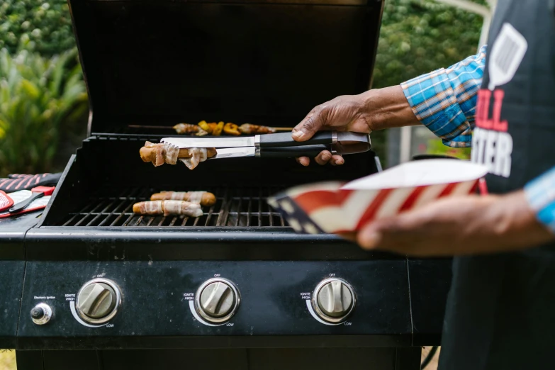 a man is cooking hot dogs on a grill, fan favorite, 3 - piece, stars and stripes, grilled chicken