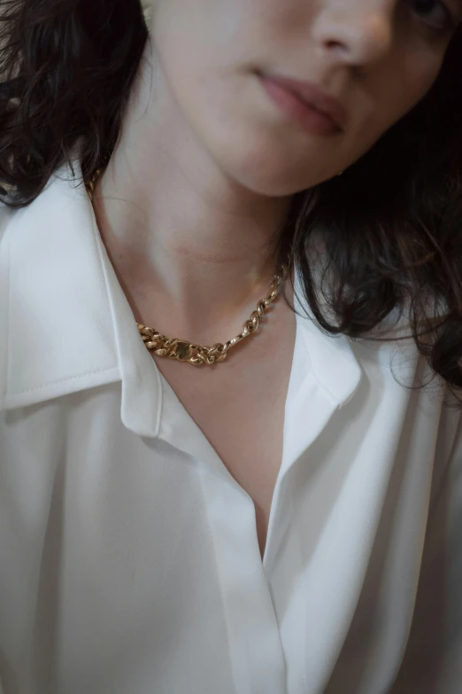 a close up of a person wearing a white shirt, by Nina Hamnett, trending on pexels, rococo, wearing a gold chain, kim hyun joo, square, wearing collar