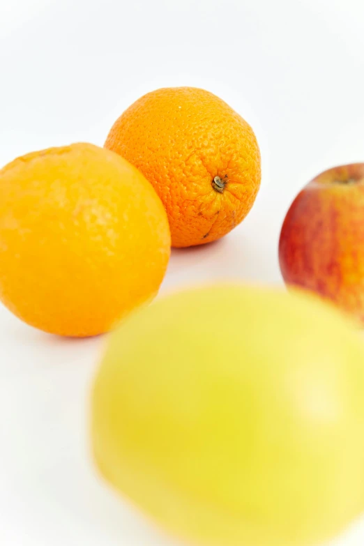 three oranges, an apple, and an orange on a white surface, pexels, 2 5 6 x 2 5 6 pixels, close up half body shot, concern, low ultrawide shot