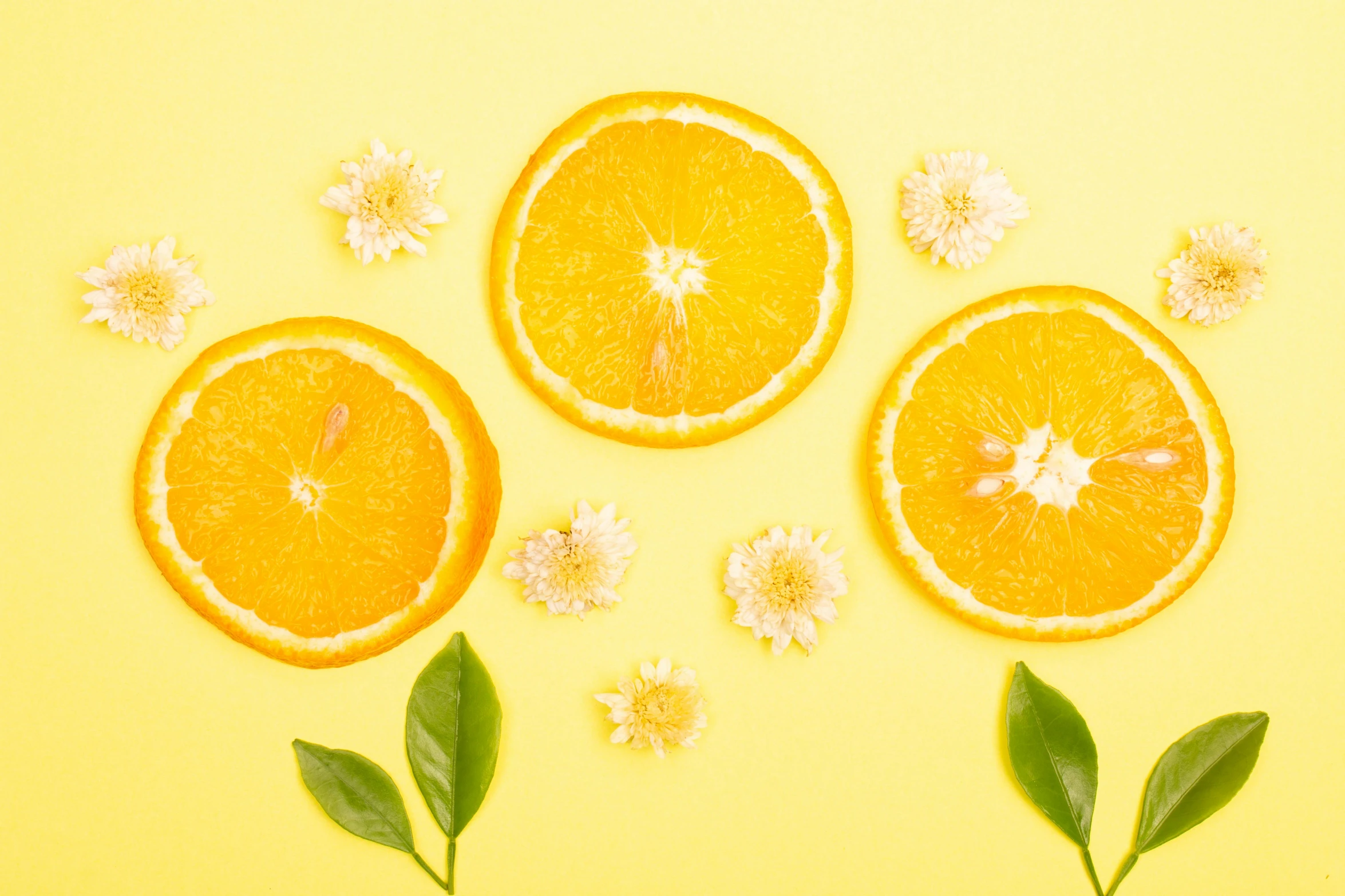 orange slices with leaves and flowers on a yellow background, trending on pexels, background image, photoshoot for skincare brand, 🐿🍸🍋, made of drink