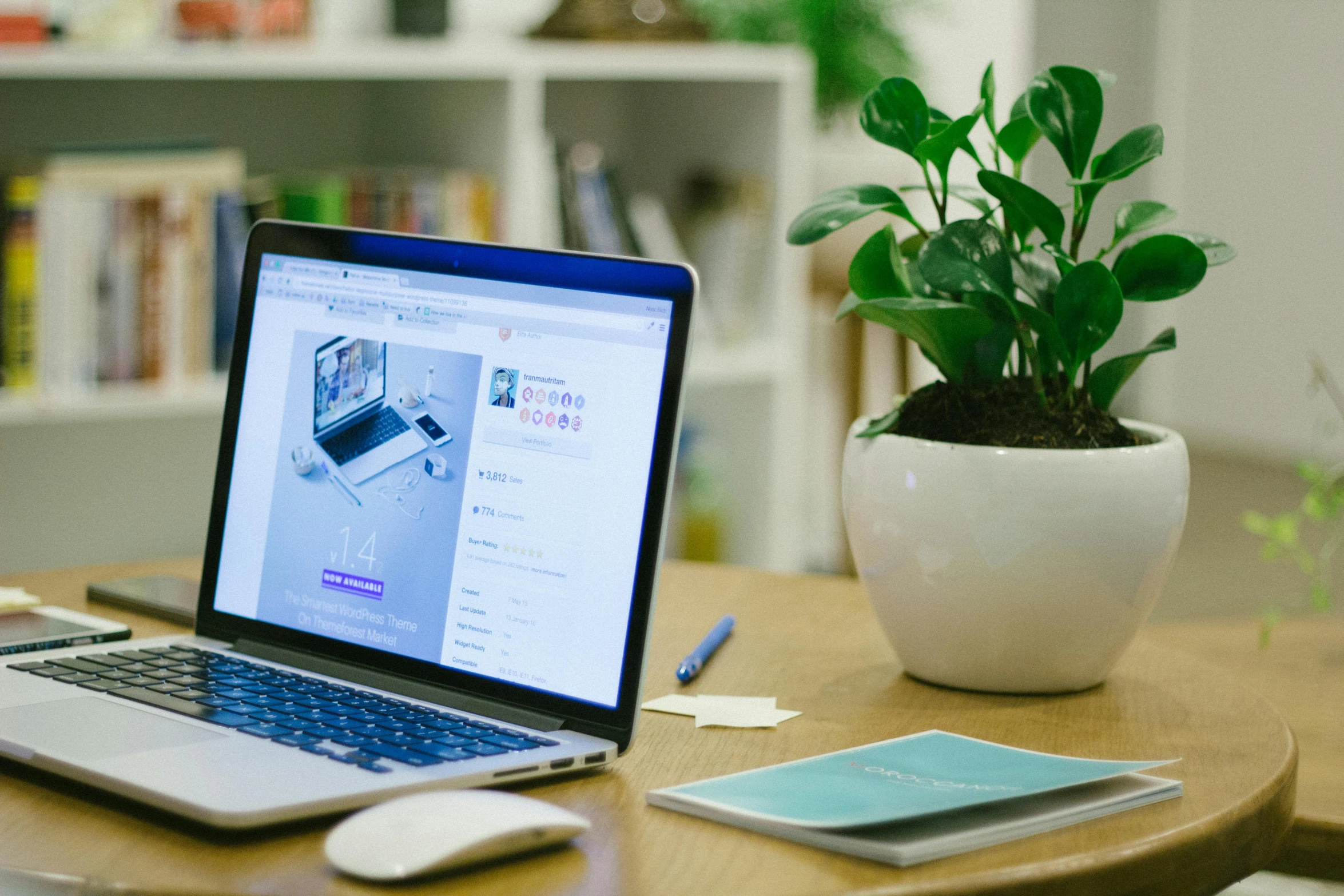 a laptop computer sitting on top of a wooden table, trending on unsplash, 9 9 designs, blue and purple scheme, in the office, next to a plant