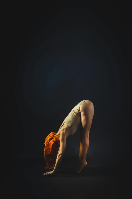 a woman doing a handstand pose against a black background, by Maciej Kuciara, medium format. soft light, sacral chakra, bum, concept photoset