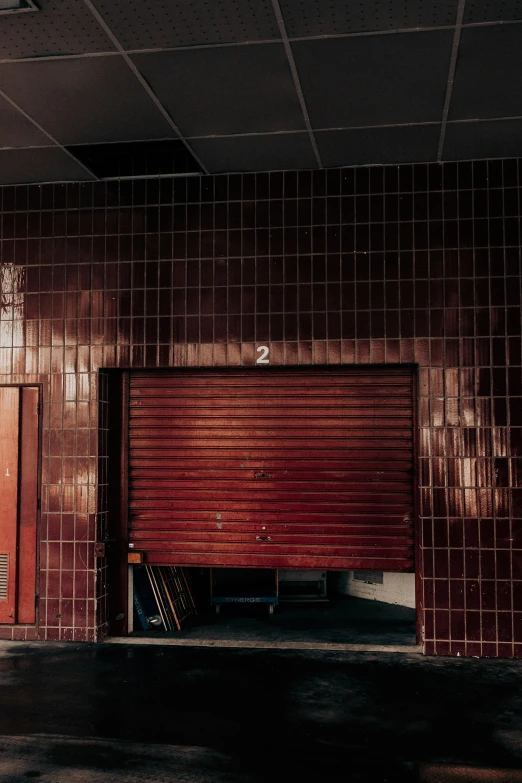 a man riding a skateboard up the side of a building, an album cover, by Elsa Bleda, unsplash, abandoned gas station, maroon, locker room, tiles