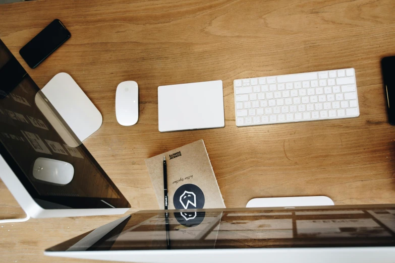 a laptop computer sitting on top of a wooden desk, by Sebastian Vrancx, trending on unsplash, brown and white color scheme, knolling, 9 9 designs, miscellaneous objects