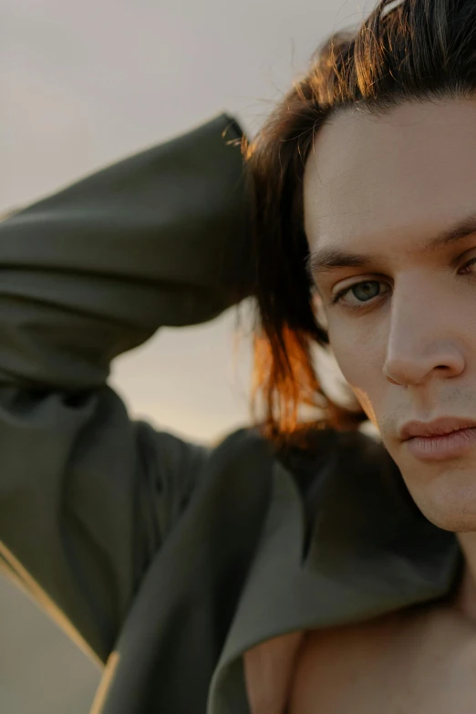 a close up of a person wearing a jacket, trending on pexels, bauhaus, jamie campbell bower, sunset mood, attractive androgynous humanoid, extremely long forehead