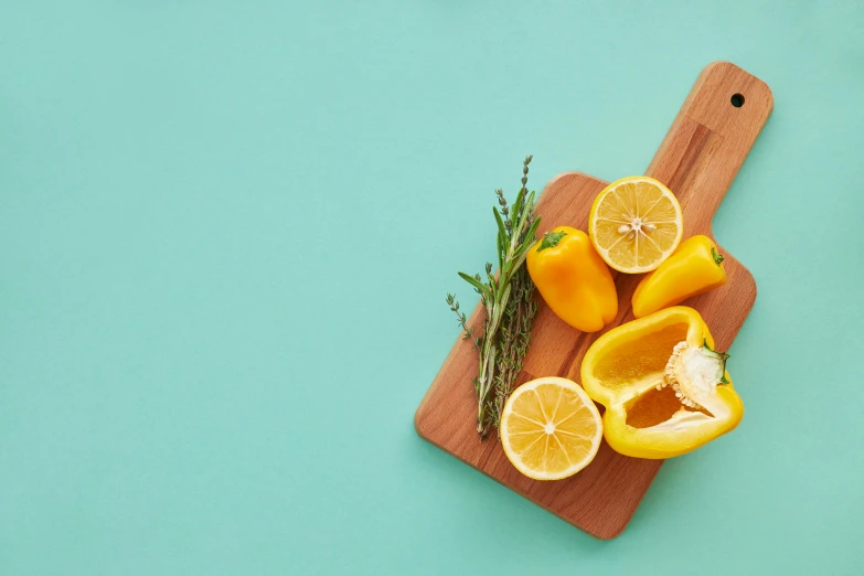 a wooden cutting board topped with sliced lemons, trending on pexels, teal studio backdrop, confident holding vegetables, 🦩🪐🐞👩🏻🦳, rounded corners