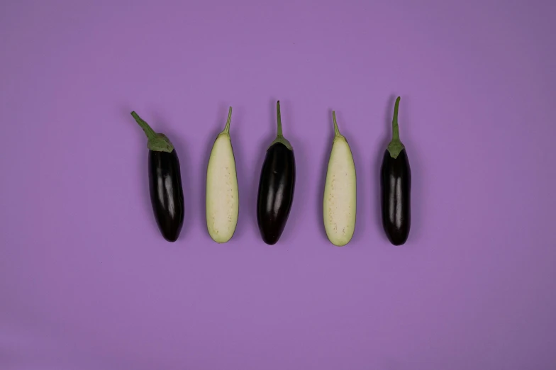 a row of eggplant on a purple background, trending on pexels, fantastic realism, five fingers, cucumber, black white purple, 🦩🪐🐞👩🏻🦳