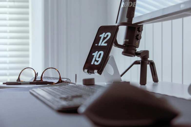 a computer monitor sitting on top of a desk next to a keyboard, by Adam Marczyński, trending on pexels, clock iconography, 3 d print, taken on iphone 14 pro, thumbnail