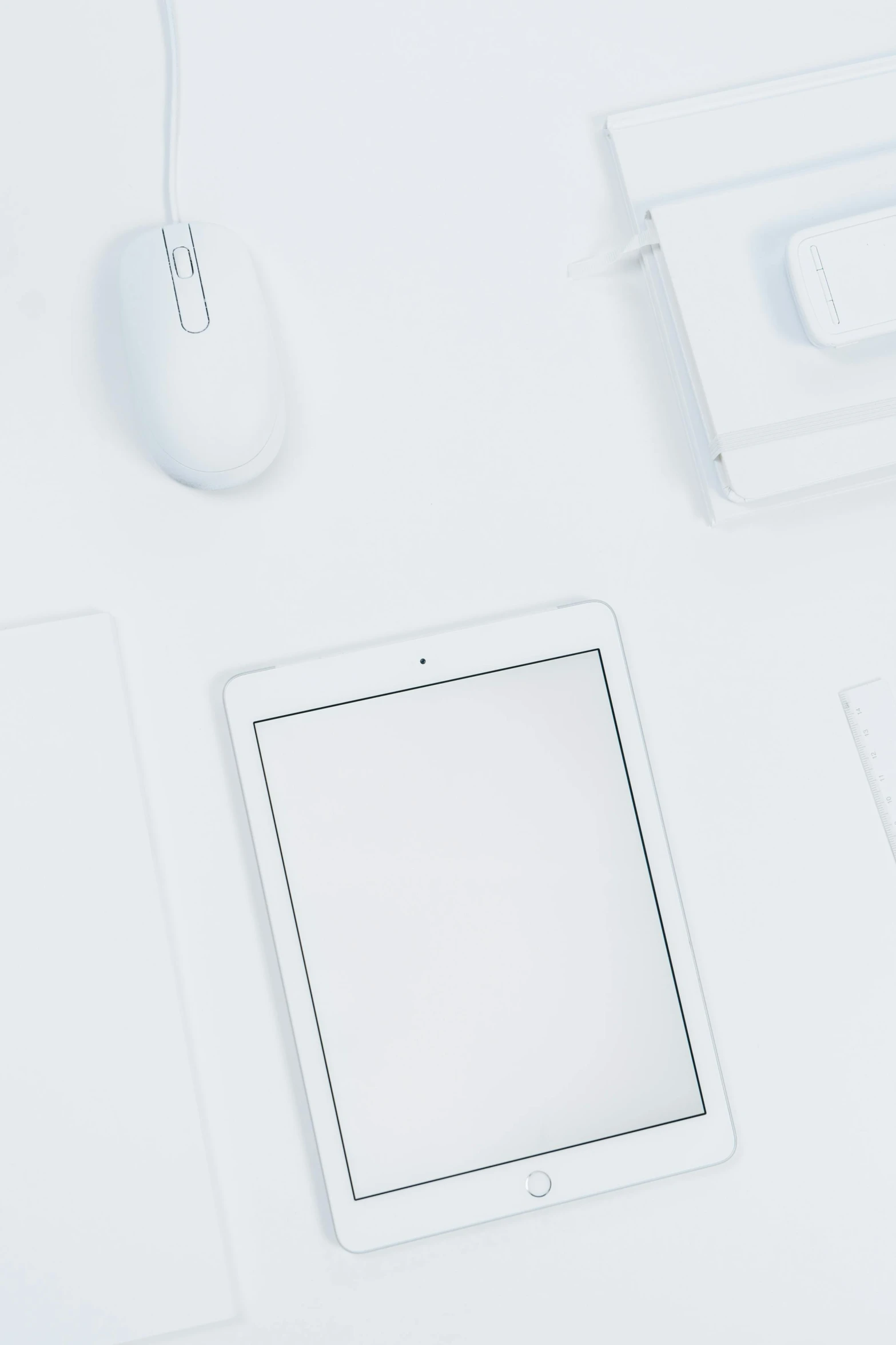 a tablet computer sitting on top of a white desk, various items, triple white colorway, white background : 3, mouse