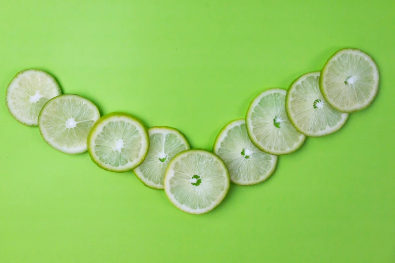lemon slices arranged in the shape of a v on a green background, trending on pexels, background image, moringa juice, lime, continuous line drawing