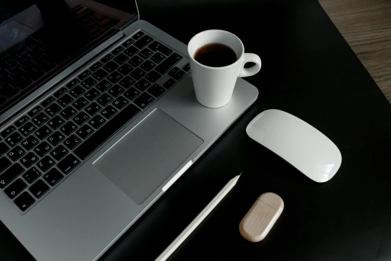 a laptop computer sitting on top of a desk next to a cup of coffee, inspired by Jan Müller, minimalism, white on black, 9 9 designs, computer mouse, no - text no - logo