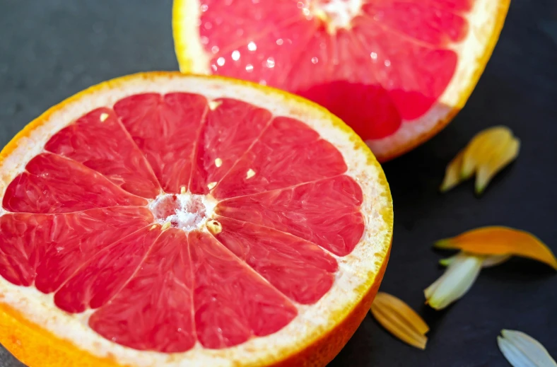 a close up of a grapefruit cut in half, trending on pexels, ingredients on the table, rubrum lillies, night time, listing image