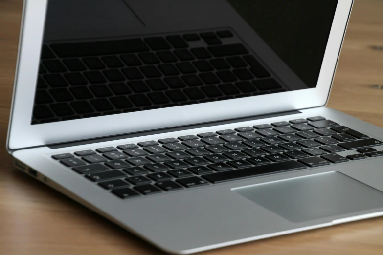 a laptop computer sitting on top of a wooden table, by Carey Morris, pixabay, silver, jets, closeup portrait shot, no cropping