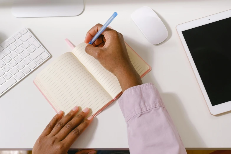 a person sitting at a desk writing in a notebook, happening, highly upvoted, full object in middle, easy to use, thumbnail