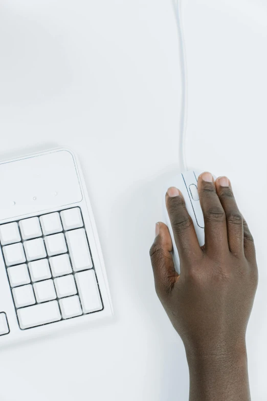 a person using a computer mouse on a desk, by Carey Morris, trending on unsplash, computer art, set against a white background, afro tech, high angle close up shot, wired