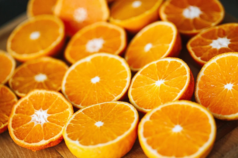 a wooden cutting board topped with sliced oranges, by Carey Morris, pexels, 🦩🪐🐞👩🏻🦳, profile pic, very crisp details, thumbnail