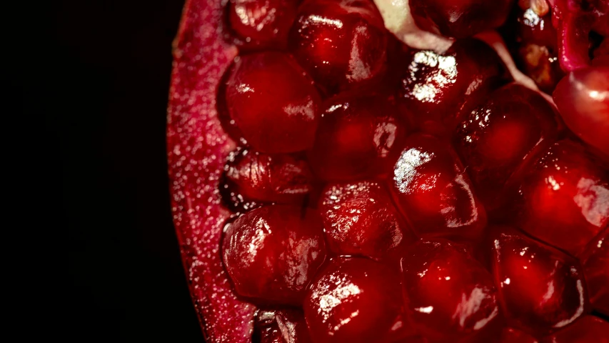 a close up of the inside of a pomegranate, a macro photograph, pexels, 1970s photo, dark red, grain”