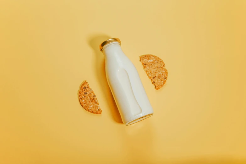 a bottle of milk and crackers on a yellow background, by Andries Stock, trending on pexels, minimalism, half moon, edible crypto, white white and gold kintsugi, white backround