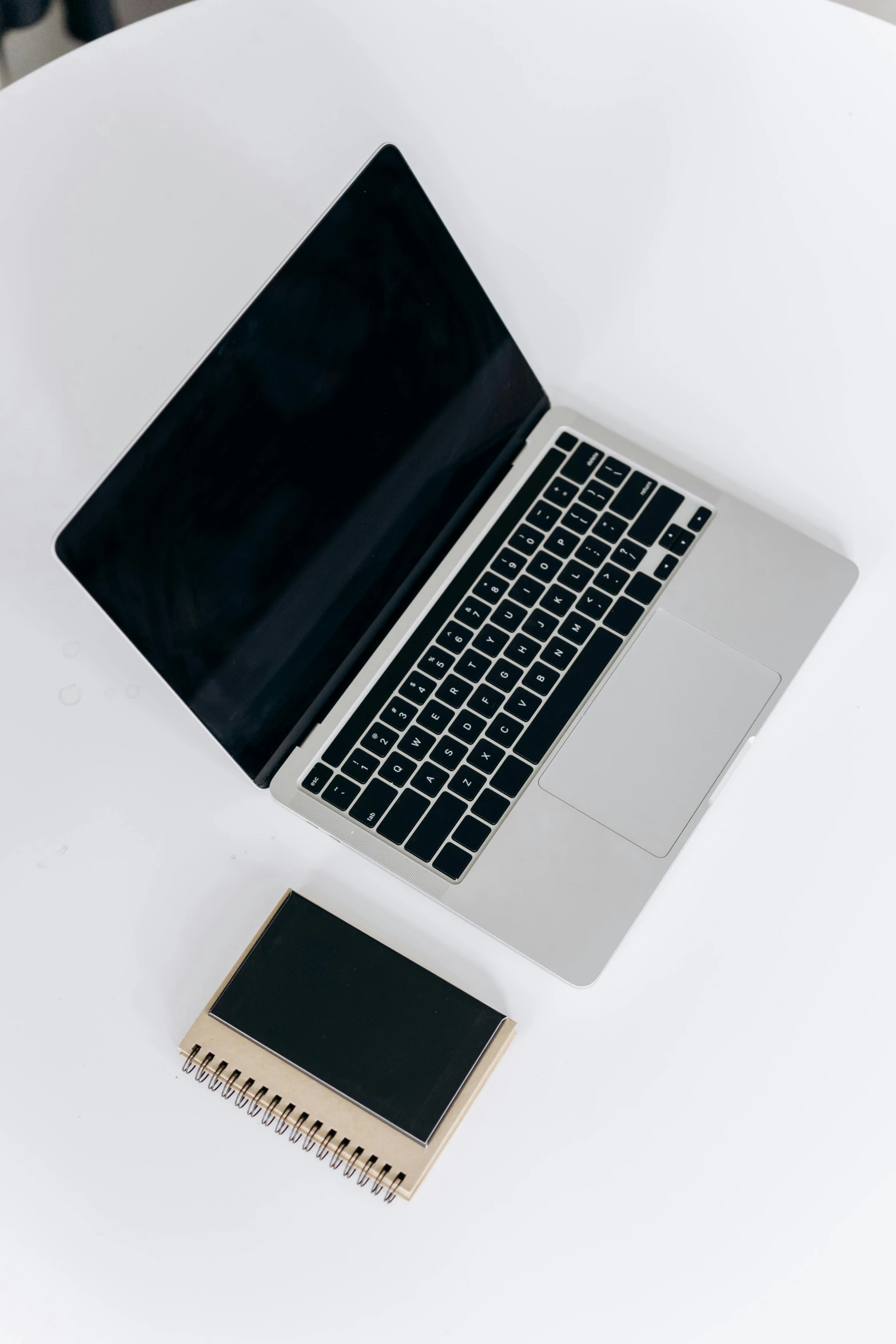 a laptop computer sitting on top of a white table, by Carey Morris, unsplash, microchips, sleek spines, flat lay, taken on iphone 14 pro