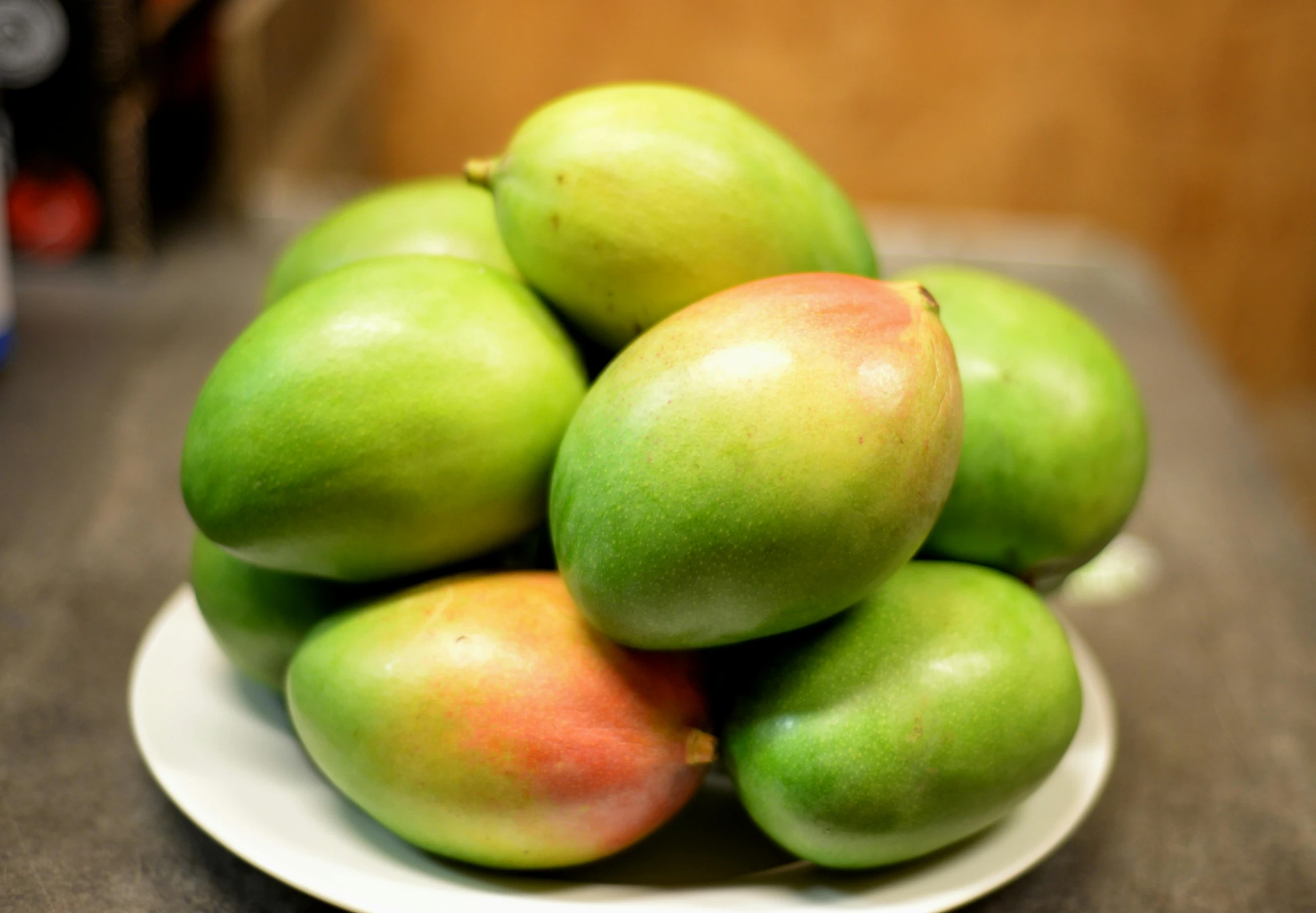a pile of mangoes sitting on top of a white plate, pale green glow, thumbnail, unedited, fan favorite