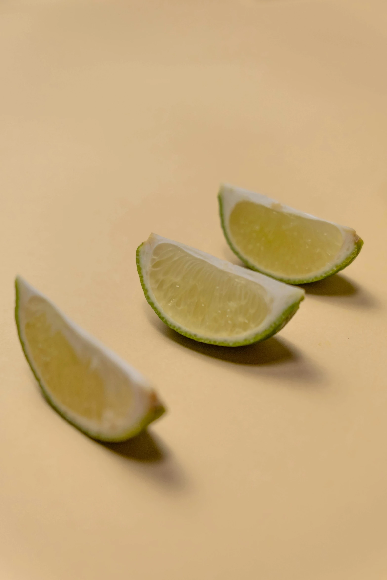 a couple of slices of lime sitting on top of a table, profile image, digital image