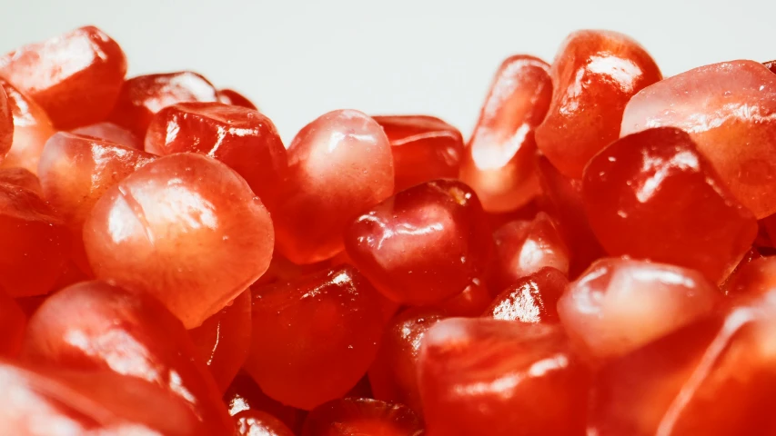 a close up of a bowl of pomegranate, a macro photograph, by Emma Andijewska, pexels, gummy candies, pearlized, thumbnail