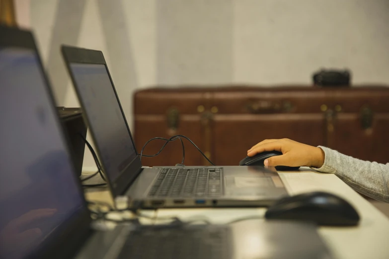 a close up of a person typing on a laptop, workshop background, holding a briefcase, profile image, multiple stories