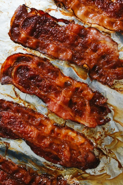 a bunch of bacon sitting on top of a sheet of foil, award - winning crisp details ”, in a row, slide show, glazed