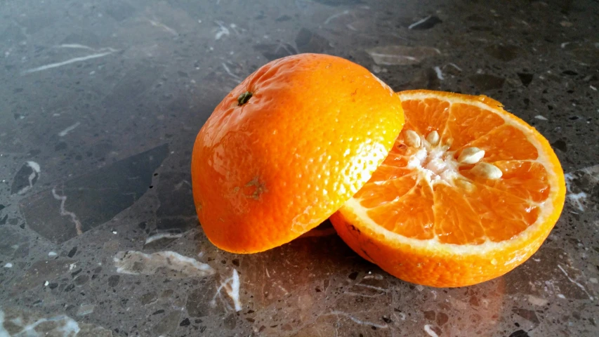 a couple of oranges sitting on top of a table, close to the camera, flattened, photograph taken in 2 0 2 0, unedited