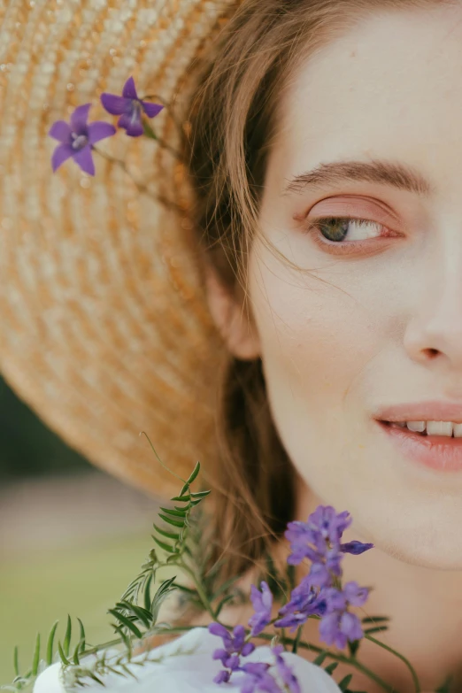 a woman wearing a straw hat with purple flowers, unsplash, renaissance, focus on face and facial details, photoshoot for skincare brand, close-up portrait film still, half image